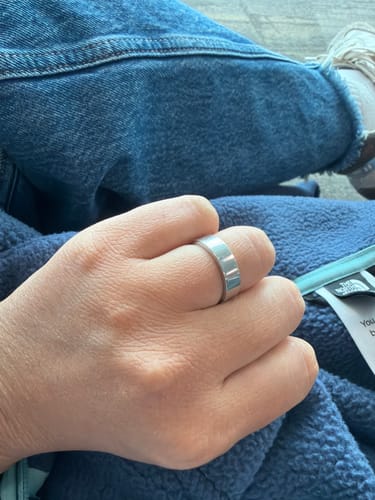 Customer's hand wearing the sleek 5mm Flat Wedding Band.
