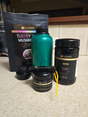 Reviewer's jar of Shilajit Resin Oil on a counter with other wellness products from the same brand.