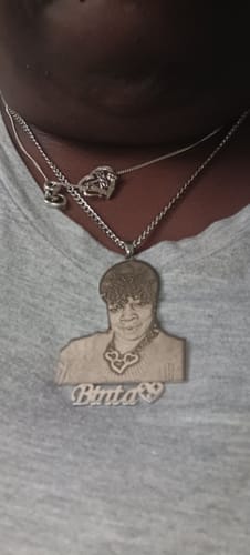 A customer wearing their Custom Photo Engraved Pendant Necklace with a nameplate, showing the detailed photo engraving.