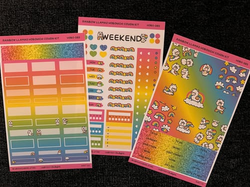 Customer's three sticker sheets from the Rainbow Llamas Hobonichi Cousin Kit, showing colorful rainbow gradients and cute llama designs.
