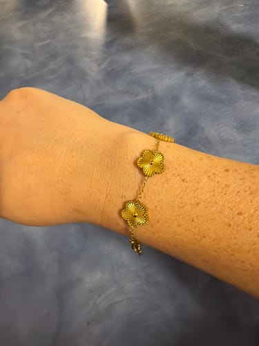 Close-up of a customer's wrist wearing the Golden Clover Bracelet.