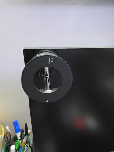 Customer's black 360° MagPro Magnetic Phone Holder by Casence attached to the side of a computer monitor.