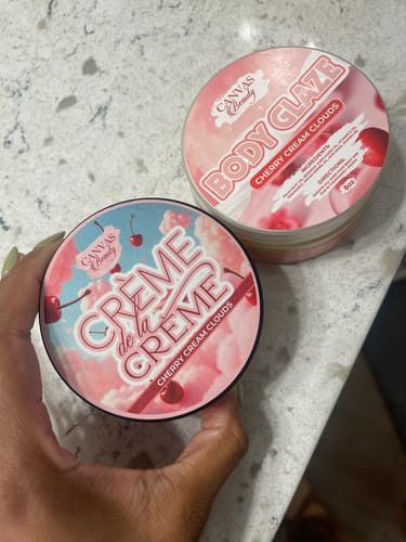 Customer showing the decorative lid of their CRÈME DE LA CRÈME body cream container.