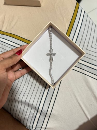 Customer holding the open box showing the elegant Zircon-Encrusted Cross Bracelet inside.