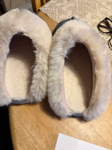 Customer's close-up photo of the Nordic Comfy Slippers, showing the thick and fluffy cream-colored lining inside.