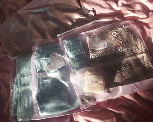 Customer showing new clothing items, including a knit set and a plaid skirt, in packaging.