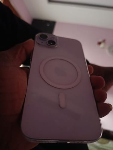 Reviewer holding the back of a purple smartphone compatible with the StickyPod.