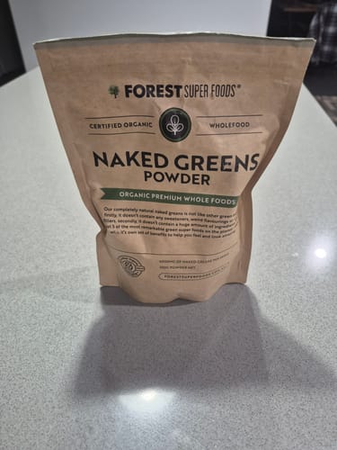 Reviewer's pouch of Naked Greens Powder sitting on a kitchen counter.