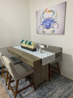 Customer's Crab Watercolor Canvas Wall Art hung above a dining table, seen from an angle.
