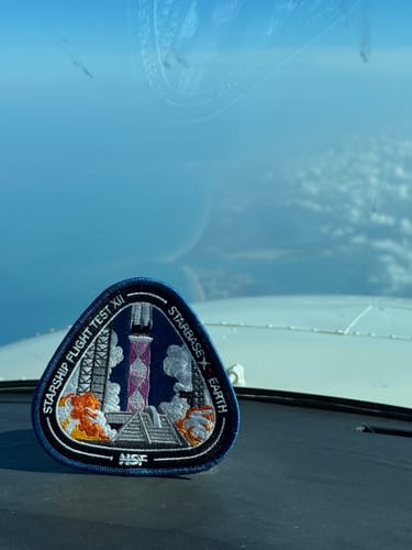 Customer's Starship Flight 12 Collectors Patch on a cockpit dashboard high above the clouds.
