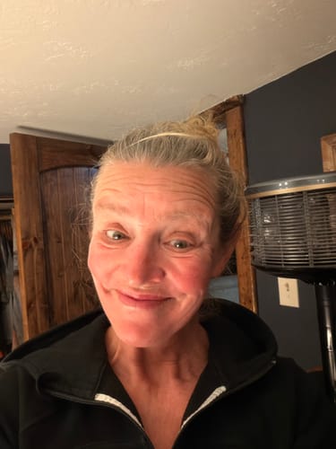 Reviewer smiling in a selfie showing their face and forehead wrinkles.