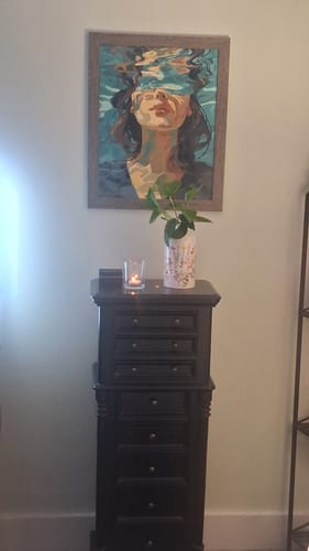Customer's finished 'Under' Paint by Number painting, framed and hanging on a wall in their room.
