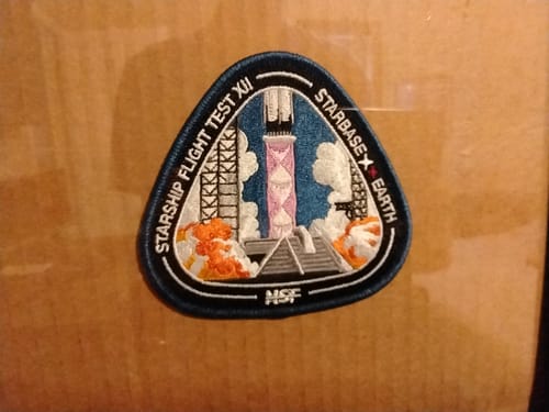 Reviewer's detailed embroidered Starship Flight 12 Collectors Patch on a surface.