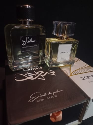 Customer's photo of two different glass perfume bottles displayed with their elegant packaging.