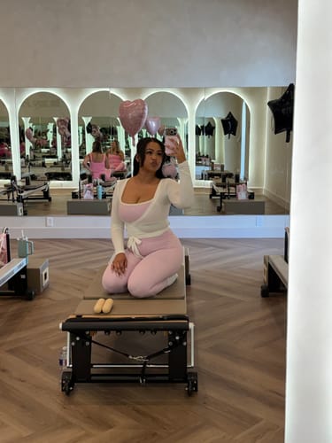 Reviewer wearing the Parfait-Cream Micro Bra and matching leggings in a fitness studio.