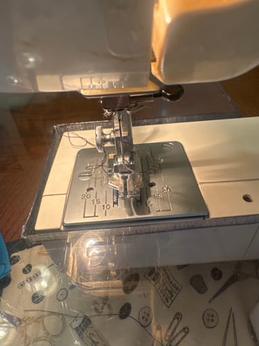 Close-up of the reviewer's 1/4" Quilting Foot installed on a vintage Kenmore sewing machine.