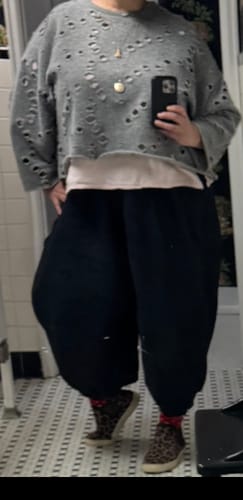 Reviewer shows the fit of the black Plus Size Casual Lantern Pants in a full-length view.