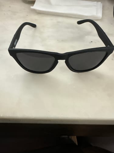 Customer's black matte 80Eighty Polarized Shady Sunglasses resting on a white marble-like surface.