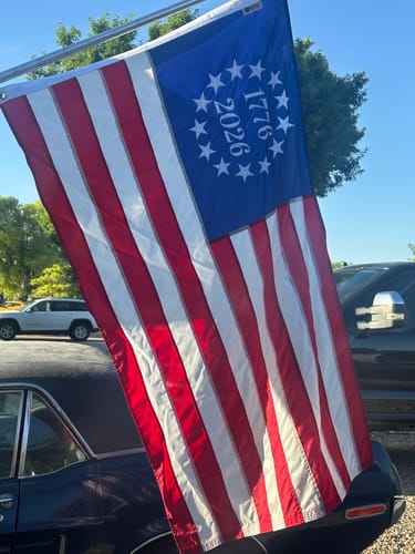 Close-up of the reviewer's 1776 to 2026 Betsy Ross Flag, showing the embroidered stars and dates.