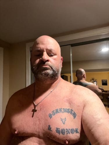 Customer showing his muscular, defined physique after using the arm workout program.