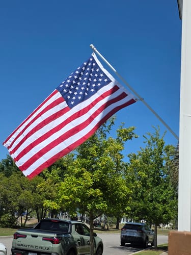 Reviewer's American flag flying on a white flagpole outdoors.