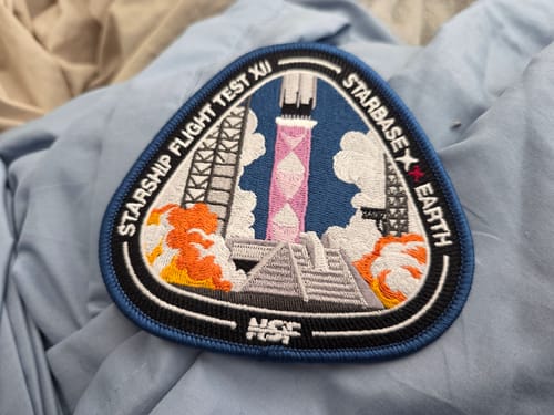 Customer's embroidered Starship Flight 12 Collectors Patch showing its colorful rocket launch design on a blue cloth.