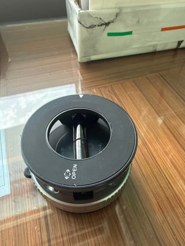 A customer's close-up image of the black 360° MagPro Magnetic Phone Holder resting on a wooden surface.