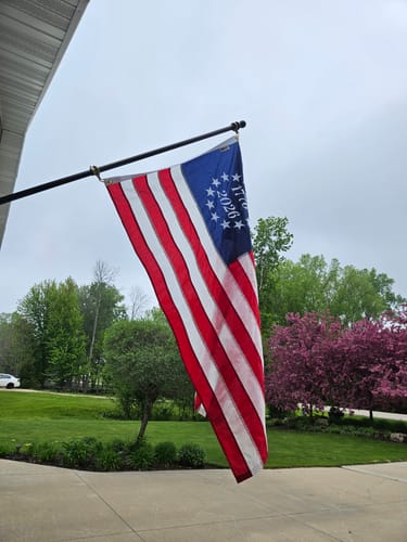 Customer's 1776 to 2026 Betsy Ross Flag flying on a flagpole outside their home.