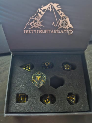 Customer's Wendigo Shattered Glass Dice Set with gold lettering displayed in a black presentation box.