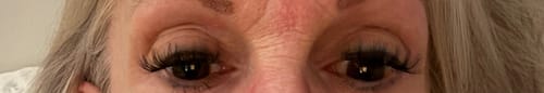 Close-up of a customer's eyes showing the full and long Lazy Girl Pre-Glued Under Lashes with a little eyeliner.