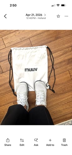 Reviewer's overhead view of their white CUURT Muuv wide toe box court shoes on a wood floor.