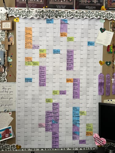 Customer's large 2026-27 School Year Calendar pinned to a bulletin board and filled out with colored highlights.