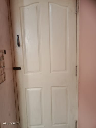 Reviewer shows a dirty white door as an example of what they cleaned with the Spray and Scrub descaler.