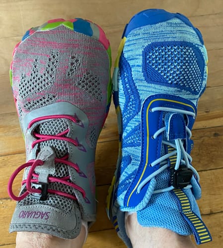 Customer comparing the blue Active II Pro Barefoot Shoes on their right foot with a different shoe on their left foot.