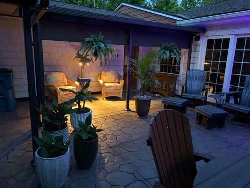 Customer's solar light used to illuminate a covered patio seating area at night.