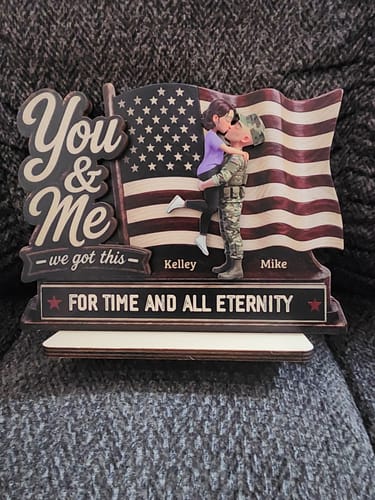 Customer's personalized 2-layered wooden plaque showing an army couple kissing in front of an American flag with custom names.