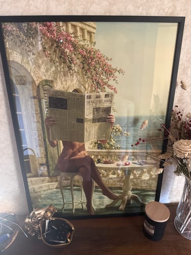 Customer's Black Oak Gallery Frame holding a large art print without a mat, resting on a wooden surface.