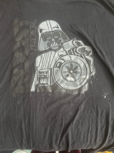 Close-up of a customer's black BoostForce Shirt, showing a gray graphic of Darth Vader holding a car turbo.