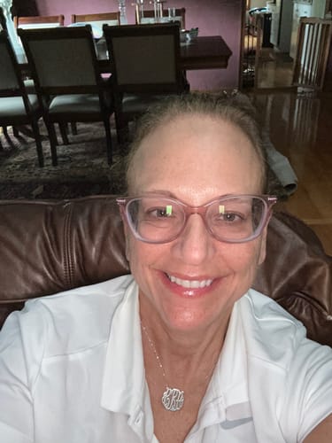 A reviewer's selfie showing her smoother skin after using the Seranova Micro Infusion System.