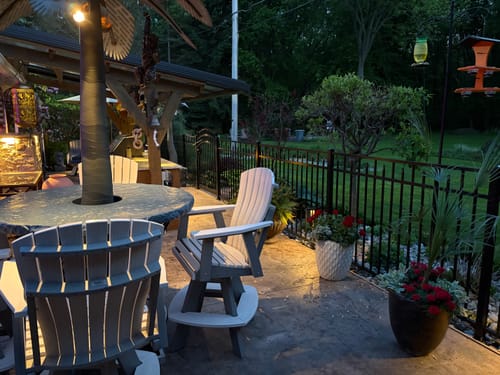 Customer's solar light mounted on a decorative feature, illuminating a patio at dusk.