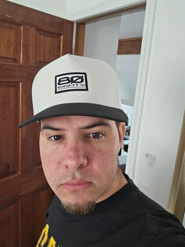 Reviewer wearing the 80Eighty® Yin-Yang Hat, which has a white front panel and black brim.