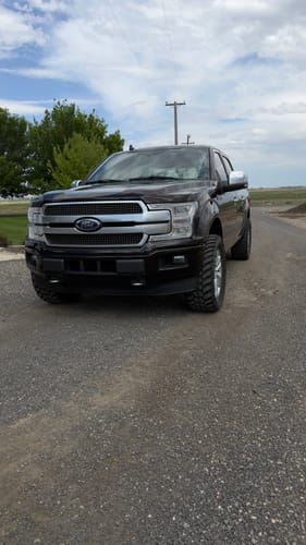Reviewer's black Ford F150 showing the wider stance created by the hubcentric wheel spacers.