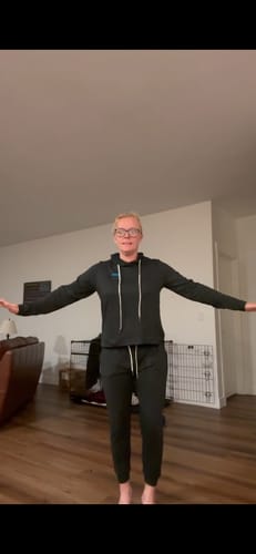 A customer models the fit of the black DawnToDusk Bundle, a matching hoodie and pants set.