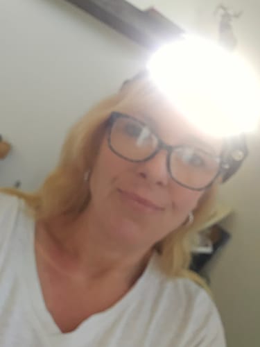 Customer wearing the 80Eighty® HeadLamp, which is on and shining with a very bright light.