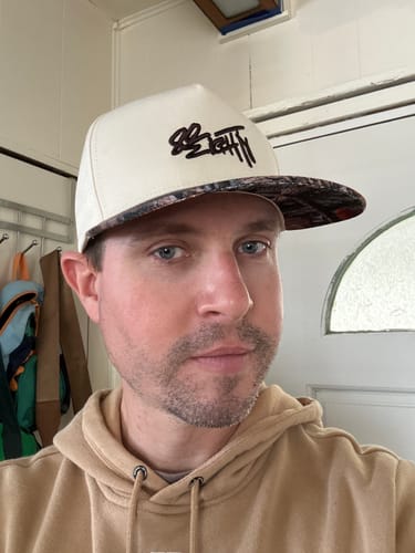 Reviewer wearing the white 80Eighty WhiteWood Hat with a patterned brim.