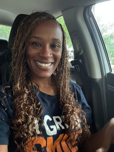 Customer in a car showing her #4/#30 Mix Color Blend Loose Deep Wave hair styled in long braids.