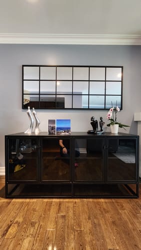 Customer's Modern Black Grid Wall Mirror mounted horizontally on a gray wall above a black console.