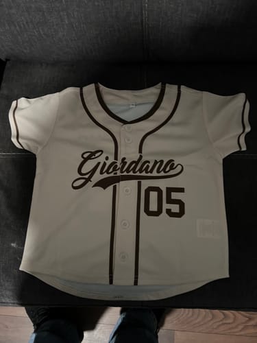 Customer's personalized cream baseball jersey showing the front name 'Giordano' and number '05' in brown.