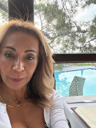 Reviewer's selfie showing smooth, glowing skin after using The Micro Infusion System.