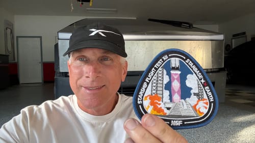 Customer smiling while holding up the embroidered Starship Flight 12 - Collectors Patch.
